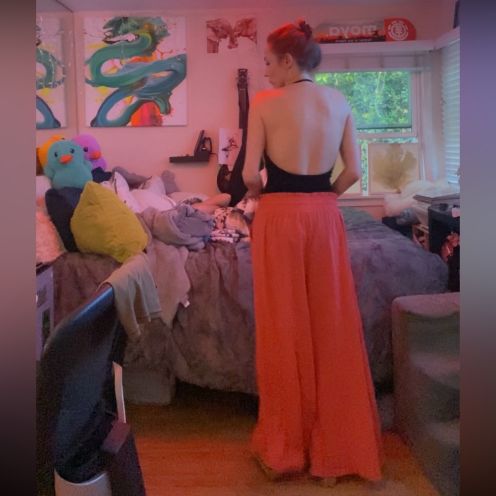 Elegant Black Top with Flowing Coral Pants
